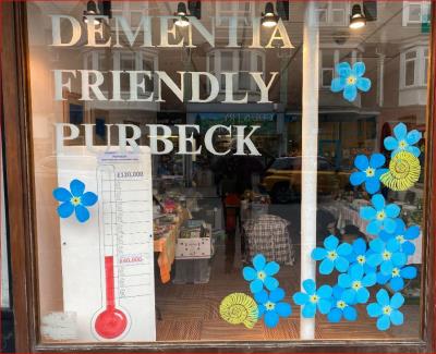 Window of charity shop in Station Road