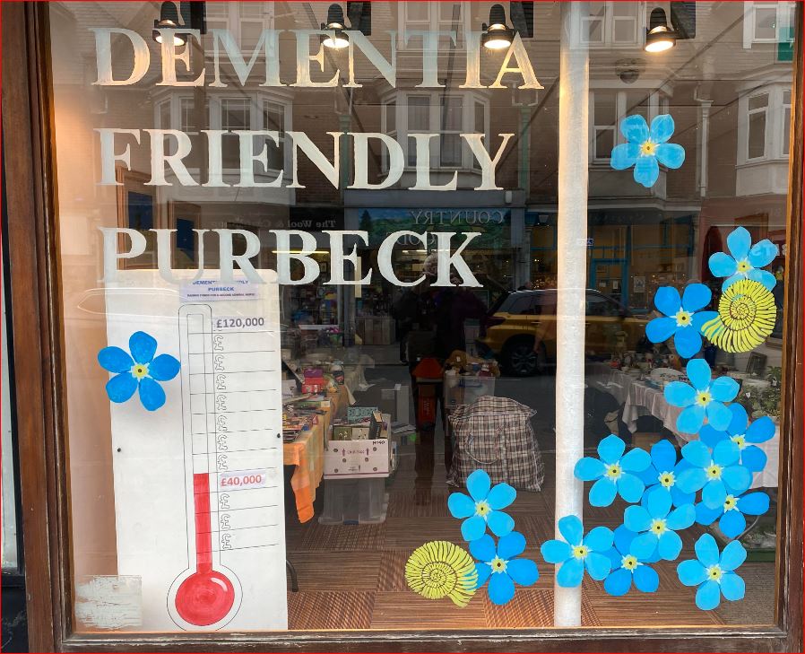Window of charity shop in Station Road